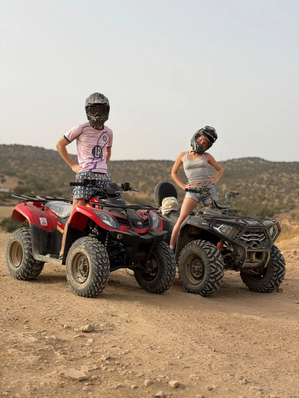 Two riders exploring a palm valley on quad bikes